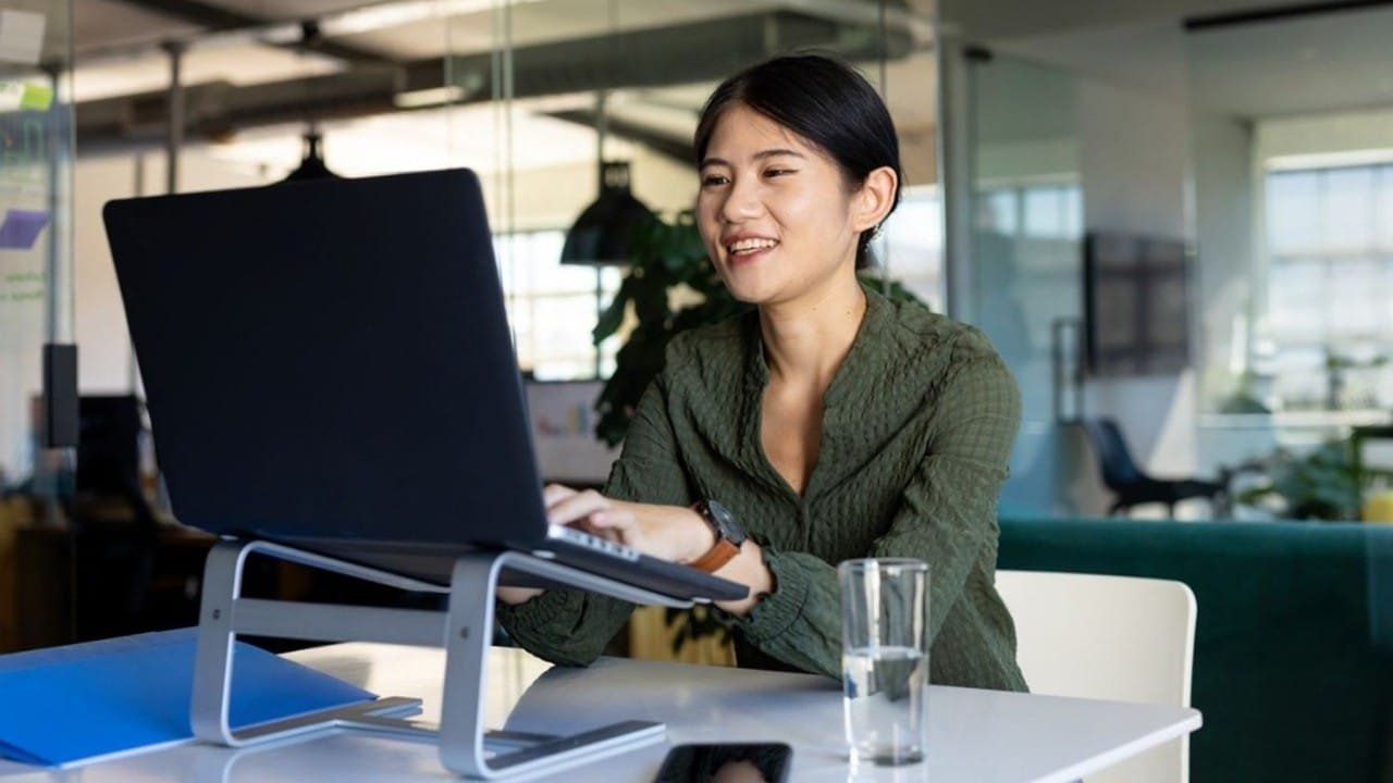 student taking notes on a laptop