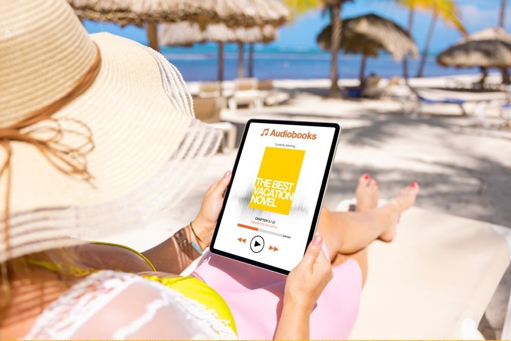 woman using ipad cellular on beach