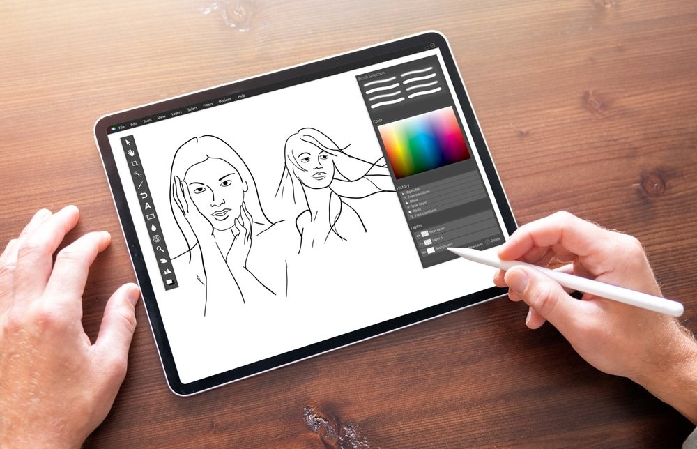 a man drawing on ipad